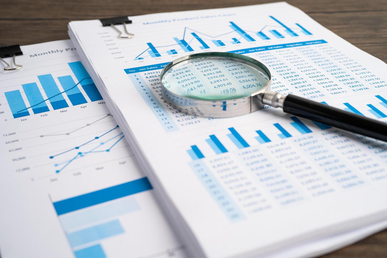 Financial reports and magnifying glass